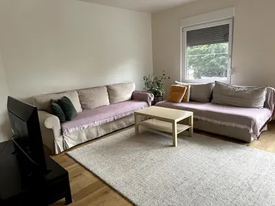 a living room with a couch and a coffee table at Cozy&Spacious apartment with garden in Antwerp