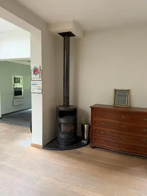 a room with a stove in the corner of a room at zandhoven vila in Zandhoven