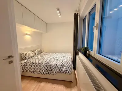 a small bedroom with a bed and a window at Louise in Mellet