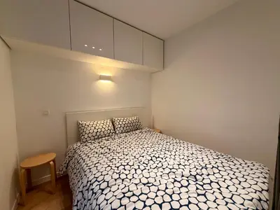 a small bedroom with a bed and a cabinet at Louise in Mellet