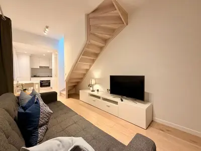 a living room with a couch and a flat screen tv at Louise in Mellet