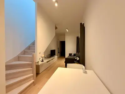 a room with a staircase and a living room at Louise in Mellet