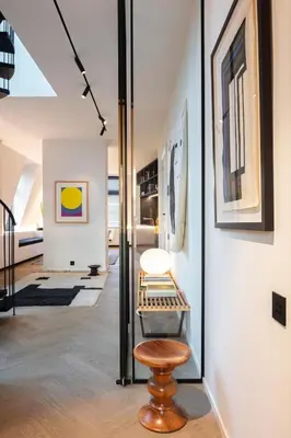 a hallway with a table and a stool in a room at Design penthouse800Y of history in one glimpse in Ghent