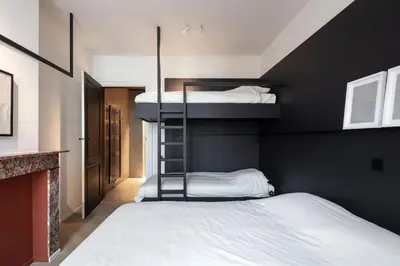 a bedroom with two bunk beds and a fireplace at Design penthouse800Y of history in one glimpse in Ghent