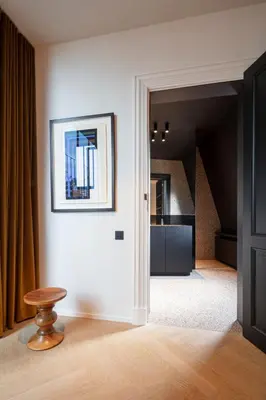 a room with a picture on the wall and a stool at Design penthouse800Y of history in one glimpse in Ghent