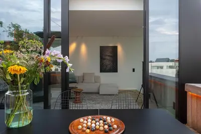 a table with a vase of eggs and flowers on it at Design penthouse800Y of history in one glimpse in Ghent