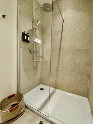 a shower stall with a glass door in a bathroom at The Twin Suites Apartment in Brussels