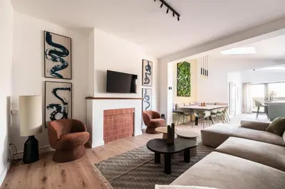 a living room with a couch and a fireplace at Spacious 5-room house near Brussels with private parking in Steenokkerzeel