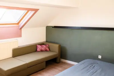 a small room with a couch and a window at Spacious 5-room house near Brussels with private parking in Steenokkerzeel