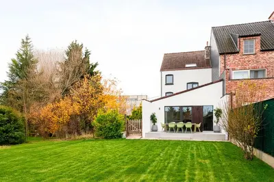 a house with a yard with green grass at Spacious 5-room house near Brussels with private parking in Steenokkerzeel