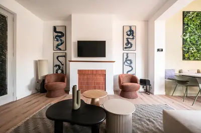 a living room with a fireplace and a tv at Spacious 5-room house near Brussels with private parking in Steenokkerzeel