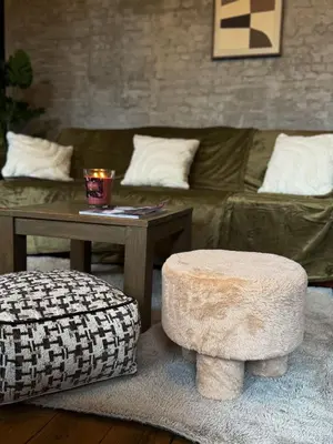 a living room with a couch and a table and a stool at NEW Luna residences - in the city center in Antwerp