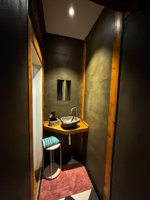 a small bathroom with a sink and a stool at NEW Luna residences - in the city center in Antwerp