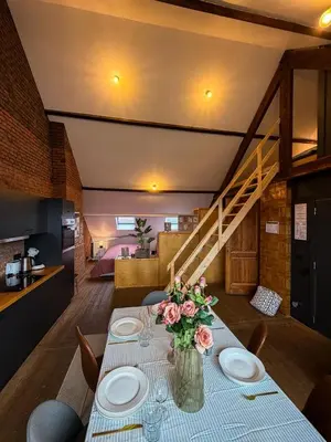 a dining room with a table with flowers on it at NEW Luna residences - in the city center in Antwerp
