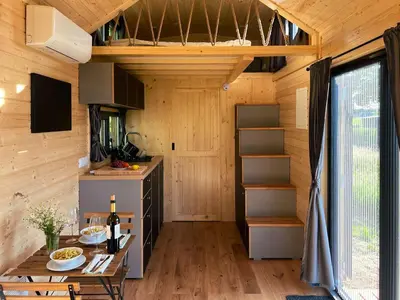 a kitchen with a table in a tiny house at Liberty Lodge X by Tiny Away in Kalmthout