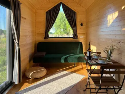 a room with a green couch and a window at Liberty Lodge X by Tiny Away in Kalmthout