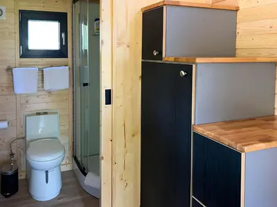 a small bathroom with a toilet and a shower at Liberty Lodge X by Tiny Away in Kalmthout