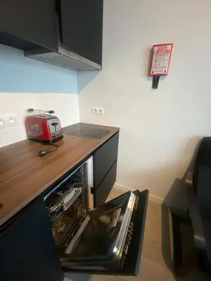 a kitchen with a toaster sitting in a dishwasher at Cosy Apartment in Antwerp in Antwerp