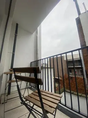 a bench sitting on the balcony of a building at Cosy Apartment in Antwerp in Antwerp