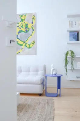 a living room with a white couch and a blue table at Stylish Apartment City Center in Antwerp
