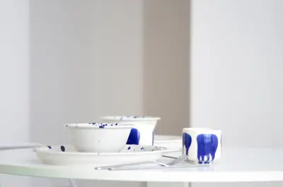 a white table with bowls and cups on it at Stylish Apartment City Center in Antwerp