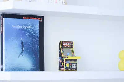 a video game on a shelf next to a book at Stylish Apartment City Center in Antwerp