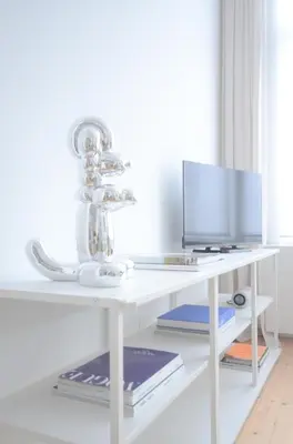 a white desk with a computer and a monitor at Stylish Apartment City Center in Antwerp