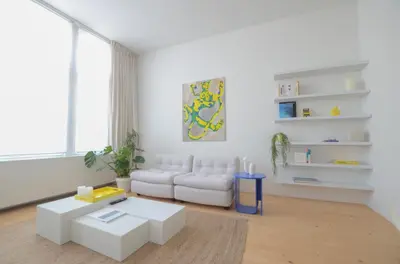 a living room with a white couch and a table at Stylish Apartment City Center in Antwerp