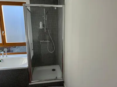 a shower with a glass door in a bathroom at Un paradis au coeur de Bruxelles in Brussels