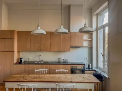 a kitchen with a large wooden table and chairs at Un paradis au coeur de Bruxelles in Brussels
