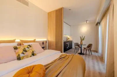 a bedroom with a large bed and a table at Stay at Brussels studio apartment in Brussels