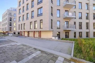 an empty street in front of a large building at Stay at Brussels studio apartment in Brussels