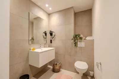 a bathroom with a white sink and a toilet at Stay at Brussels studio apartment in Brussels