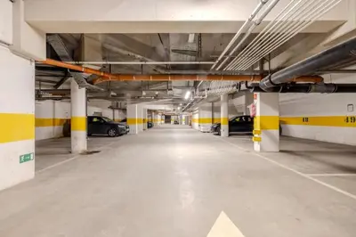 an empty parking garage with cars parked in it at Stay at Brussels studio apartment in Brussels
