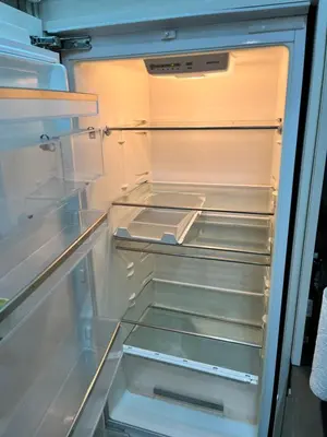 an empty refrigerator with its door open and its drawers at Central in Ghent
