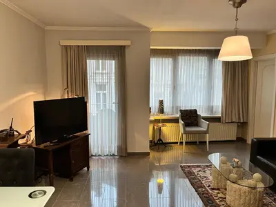 a living room with a flat screen tv and a couch at Central in Ghent