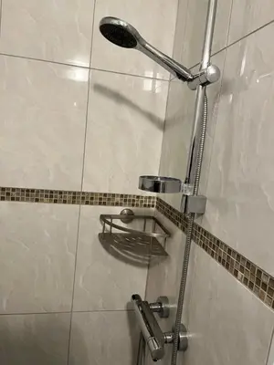 a shower with a shower head in a bathroom at Central in Ghent