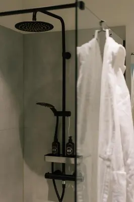 a shower with two cameras on a shelf in a bathroom at A Place Antwerp - Boutique Suites & Flats - Vrijdagmarkt 18 in Antwerp