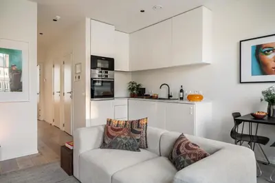 a living room with a couch and a kitchen at A Place Antwerp - Boutique Suites & Flats - Vrijdagmarkt 18 in Antwerp