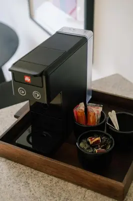a printer on a wooden tray with a bowl of food at A Place Antwerp - Boutique Suites & Flats - Vrijdagmarkt 18 in Antwerp