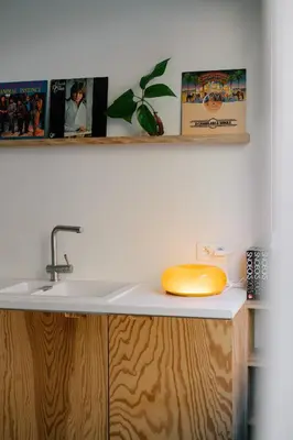 a kitchen sink with a yellow phone on a counter at A Place Antwerp - Boutique Suites & Flats - Leeuwenstraat 15 in Antwerp