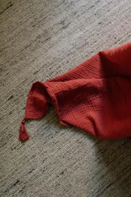 a red tie laying on the floor at A Place Antwerp - Boutique Suites & Flats - Leeuwenstraat 15 in Antwerp