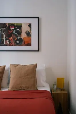 a bedroom with a bed with a picture on the wall at A Place Antwerp - Boutique Suites & Flats - Leeuwenstraat 15 in Antwerp