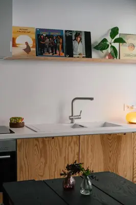 a kitchen counter with a sink and a table at A Place Antwerp - Boutique Suites & Flats - Leeuwenstraat 15 in Antwerp