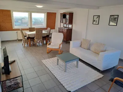 a living room with a couch and a table at De Peperbus in Lokeren