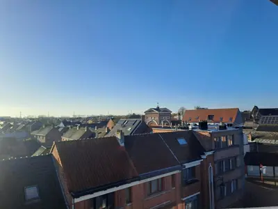 a view of a city with houses and roofs at De Peperbus in Lokeren