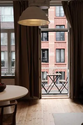 a large window with a view of a building at Cozy Parisian-Style Flat in Antwerp Zuid in Antwerp