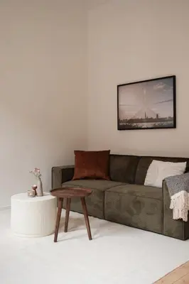 a living room with a couch and a table at Cozy Parisian-Style Flat in Antwerp Zuid in Antwerp
