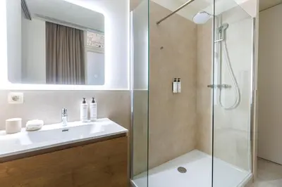 a bathroom with a sink and a shower at Le Catherine by Sweett in Brussels