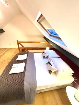 a bedroom with a large bed with a window at EU District Loft in Brussels